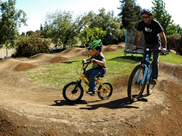 Father and son enjoy a bike park ride