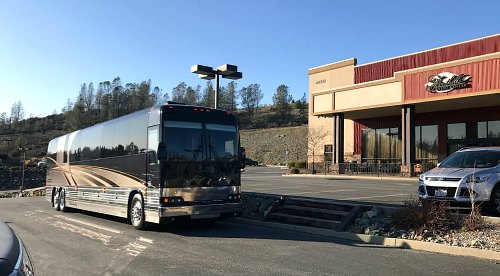Tour bus parked in front of the Foothills Event Center