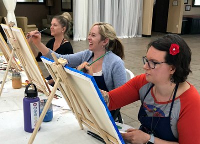 Women having fun at a recent Come Paint With Us class